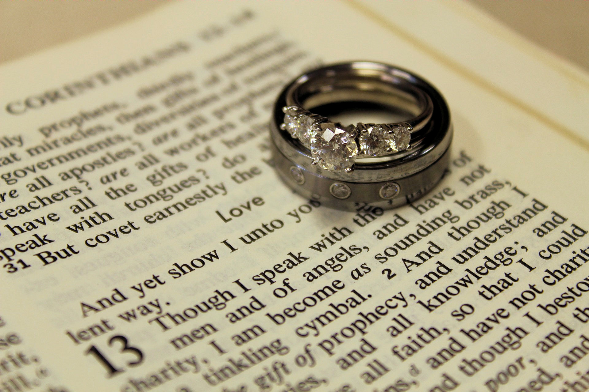 Bible open at 1
Corinthians 13 with wedding and engagement rings
lying on the page