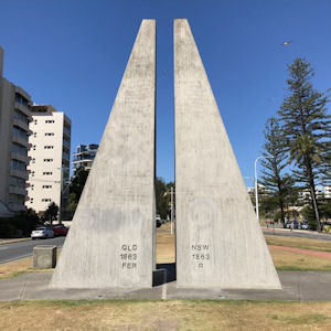 The Centernary of
Federation Marker for the border between
Queensland and New South Wales. Grey concrete
triangles reaching up into the sky on either side
of a painted line