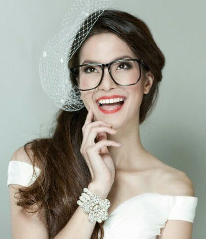 Laughing bride wearing glasses and bright
lipstick
