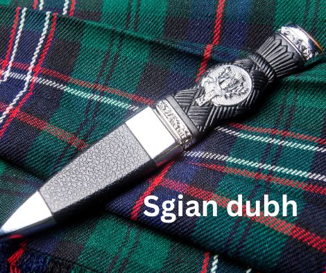 A Scottish sgian dubh, sheathed, lying on
                          a tartan kilt