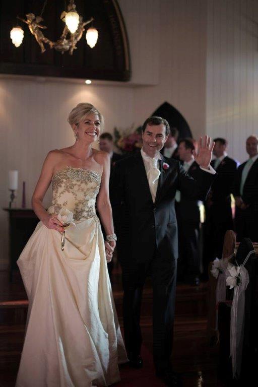 Katie & Lachie
walk back up the aisle after their 'white
wedding' renewal of vows at the Broadway Chapel